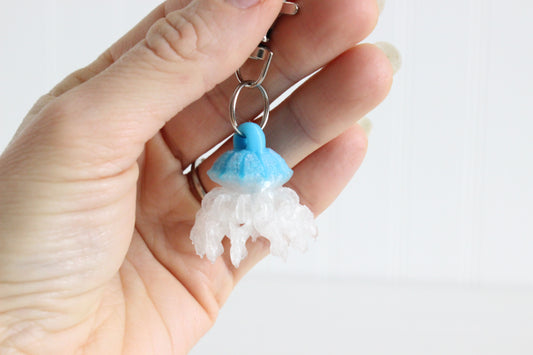 3D-printed jellyfish keychain with a silver swivel quick-clip held in a hand.