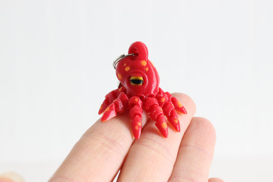 Alternate view of the 3D-printed octopus with curled tentacles keychain showing its sculpted details and segmented design.