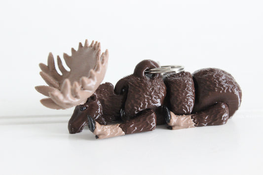 3D-printed brown moose with antlers keychain with a silver swivel quick-clip on a white background.