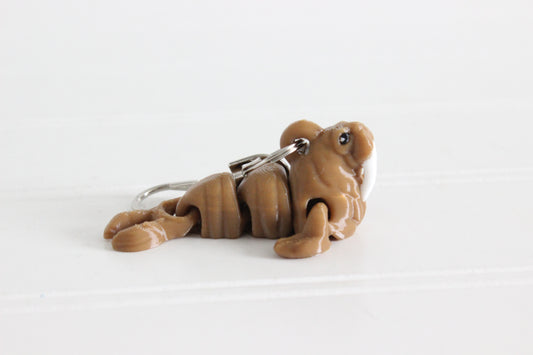Alternate view of the 3D-printed brown walrus with white tusks keychain showing its sculpted details and segmented design.