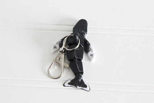 Alternate view of the 3D-printed humpback whale keychain showing its sculpted details and segmented design.