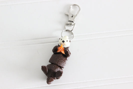 3D-printed brown sea otter keychain with a silver swivel quick-clip on a white background.