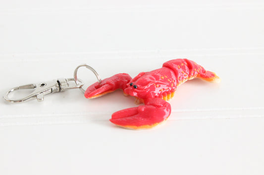 3D-printed red lobster keychain with a silver swivel quick-clip on a white background.