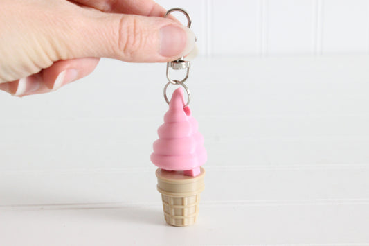 Alternate view of the 3D-printed strawberry soft-serve ice cream cone keychain showing its shape, color, and key-ring attachment.