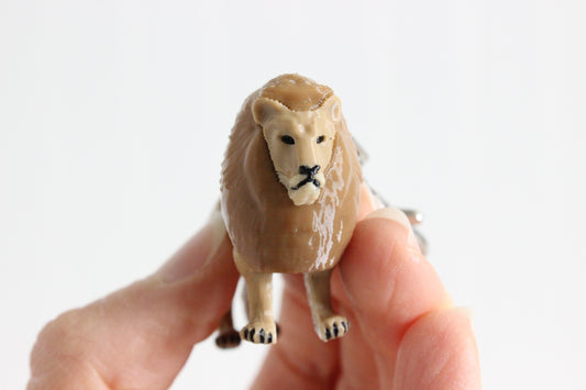 3D-printed golden lion keychain with a silver swivel quick-clip on a white background.