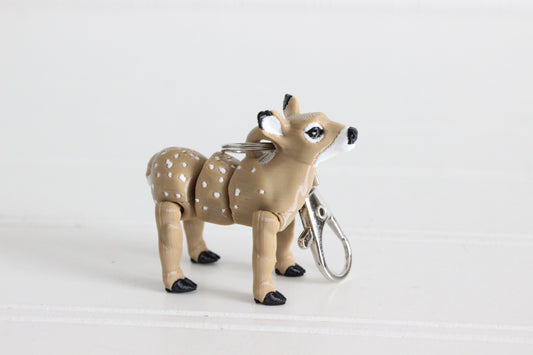 3D-printed brown doe keychain with a silver swivel quick-clip on a white background.