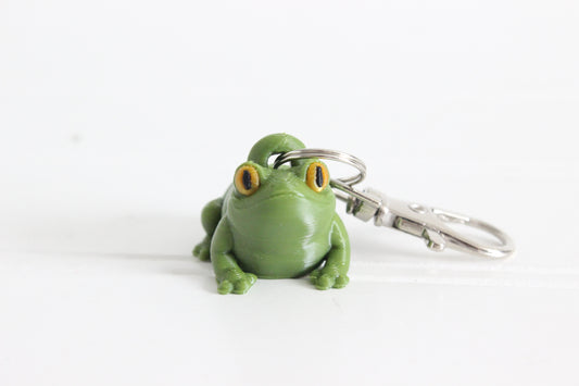 Alternate view of the 3D-printed green frog keychain showing its sculpted details and segmented design.