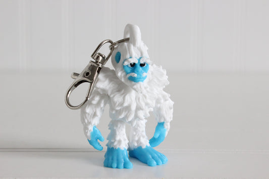 Alternate view of the 3D-printed blue-and-white keychain showing its sculpted details and segmented design.