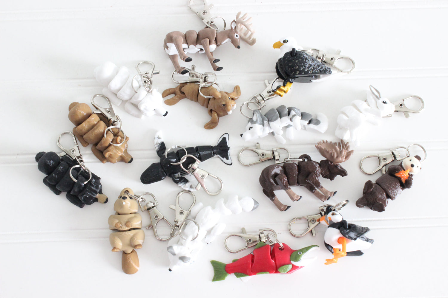 Partial Northern Collection featuring articulated wildlife keychains including moose, bald eagle, orca, polar bear, beaver, salmon, puffin, and other northern animals.