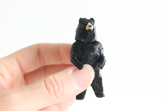 Standing Back Bear held in a person's hand