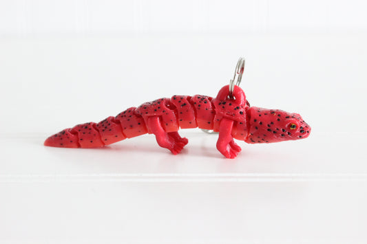 3D-printed red salamander keychain with a silver swivel quick-clip on a white background.